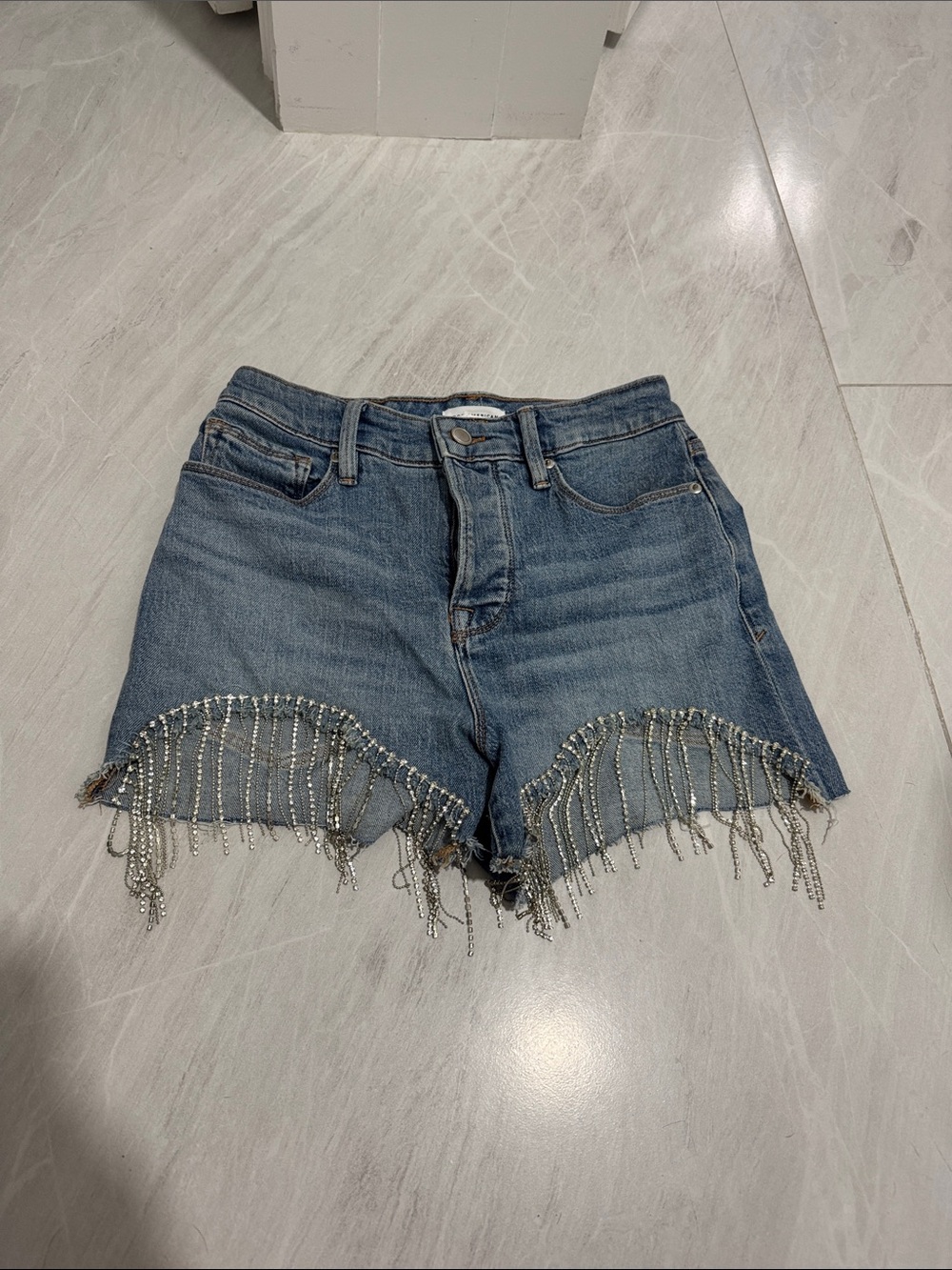 Good American Bombshell Blue Denim Shorts with Beaded Fringe